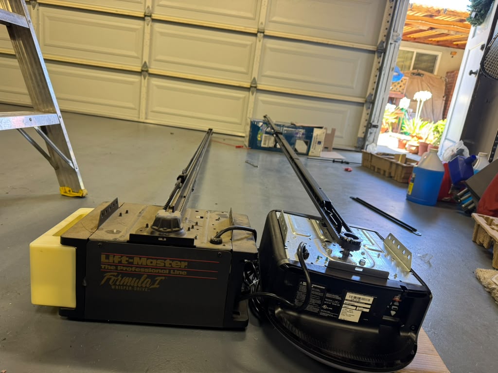 Old garage door opener removed and new opener ready for installation on the garage floor