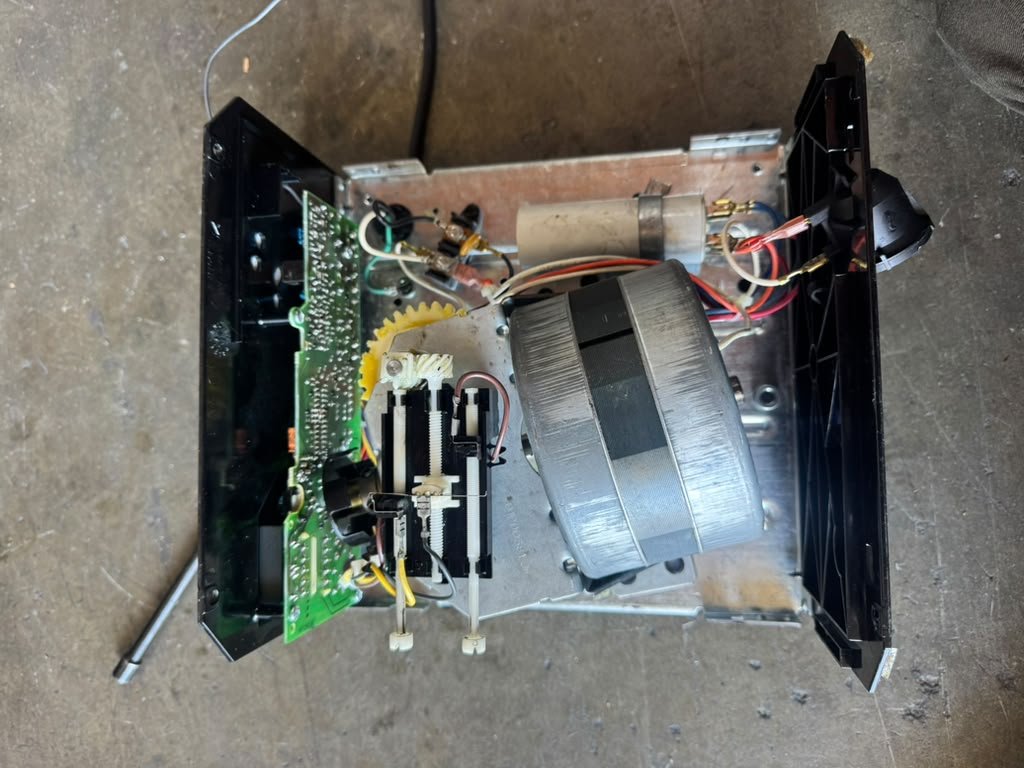 Internal garage door opener assembly showing the motor, circuit board and wiring during diagnosis